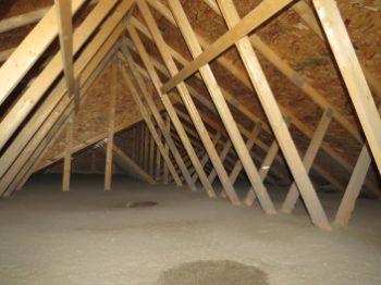 Increase insulation in the attic to reduce heat loss into the attic which melts the snow.