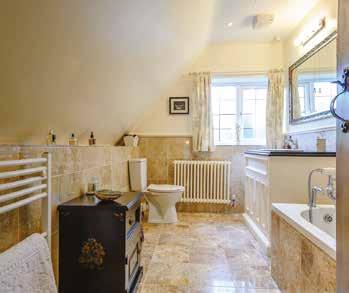 This space flows through to the well-proportioned ENSUITE finished to a good standard, with marble tiling to floor and walls, white suite, wc, hand basin set into wooden vanity