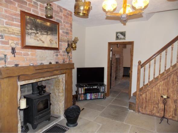 breast, stone interior and fitted with a cast iron multi-fuel stove Antique style radiator with brass fittings that sits under the front window Timbered staircase to the