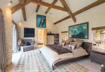 The master bedroom suite with vaulted ceiling has an en-suite luxury bathroom with free standing stone bath and double walk-in rain shower.