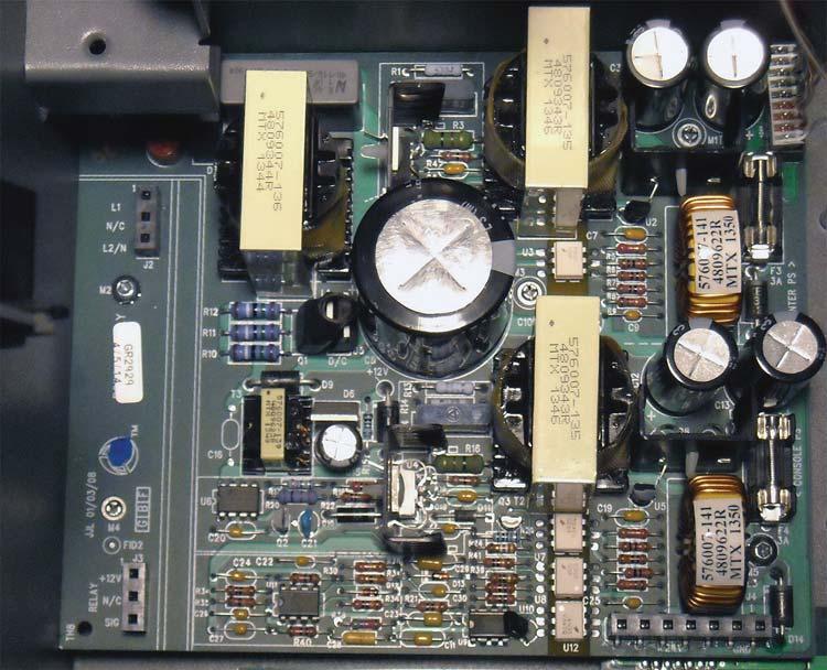 7 Component Removal Removing The AC Input Filter And Power Supply Board 10.Lift the board out of the console by its edges since there is still undischarged high voltage in the item 3 capacitors.