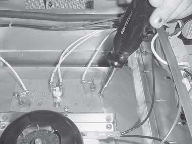 Figure 3-30 2. Unplug the wires to the heater and high limit. Figure 3-30. 3. Using a Phillip s head screwdriver, remove the 4 screws securing the heater and remove heater.