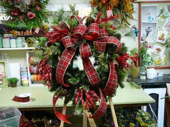 So what do you think of the wreath so far? As you can see, I added the red leafy filler on the sides of the wreath as well as the top and bottom.