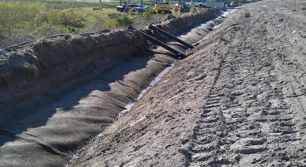 To prepare the area for construction of the LTDS, the slope is regraded such that a shallow depression at the toe of the slope can be created within the sand layer previously placed over the landfill