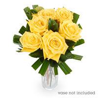 white roses arranged in lush foliage and wrapped in beautifully coloured paper Bouquet of