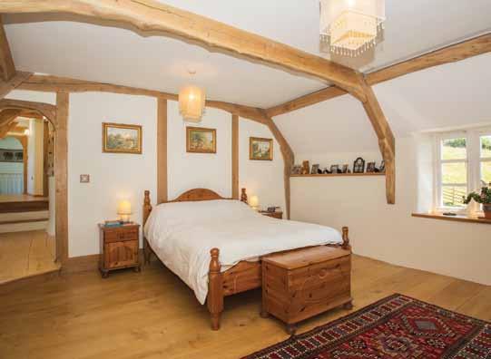 fireplace, plank and muntin screen, countless exposed beams and roof timbers, solid oak doors with hand-forged iron work and, in addition to the splendid main stairs, there is even a secret staircase