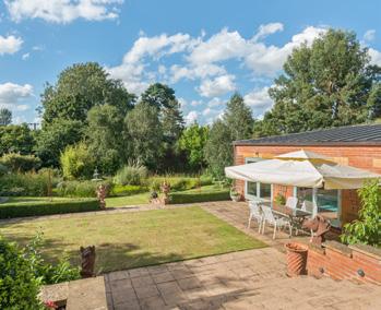 The main garden is to the rear of the house and incorporates a sound system, mood lighting, herbaceous borders, mature trees, shrubs, pond, greenhouse and shed.