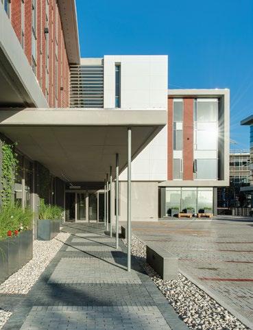 The building entrance is on the raised parking deck, accessible from the street level directly at all hours, which has been conceived as an urban square in feeling and
