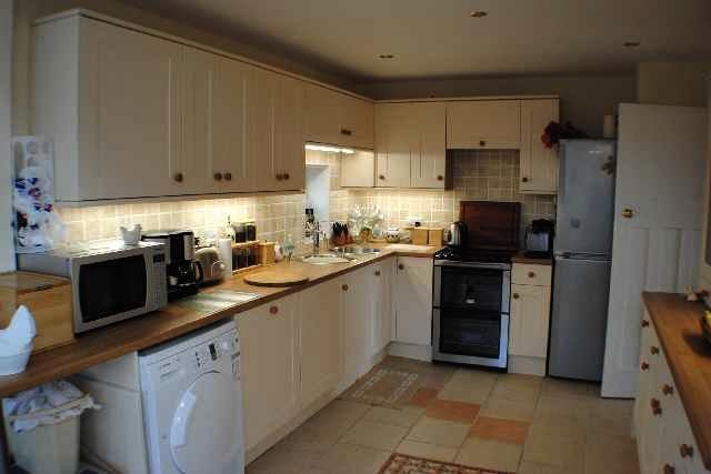appliances include dishwasher, washing machine, part tiled, tiled floor, recessed ceiling lights. Open plan through to the Sun Lounge.