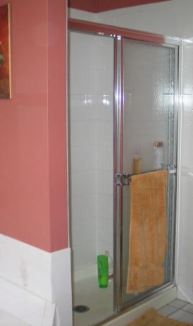 The framed chrome shower door and lack of storage space made the interior of this 3 foot x 4 foot shower feel cramped.