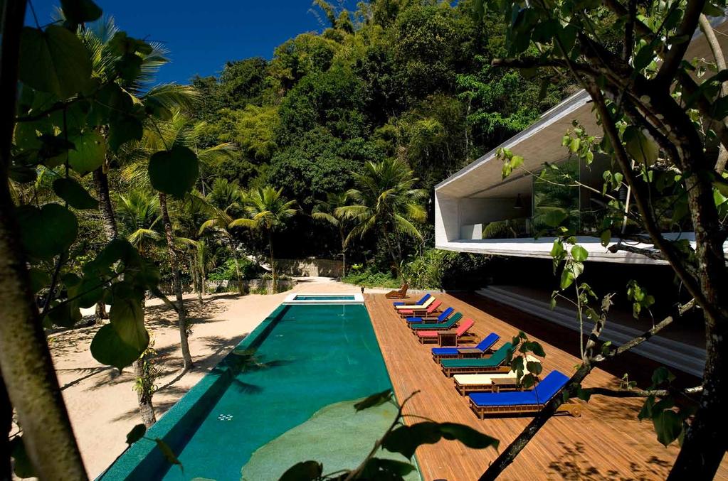 An ipe-wood deck leads seamlessly to an infinity pool and into the beach beyond.