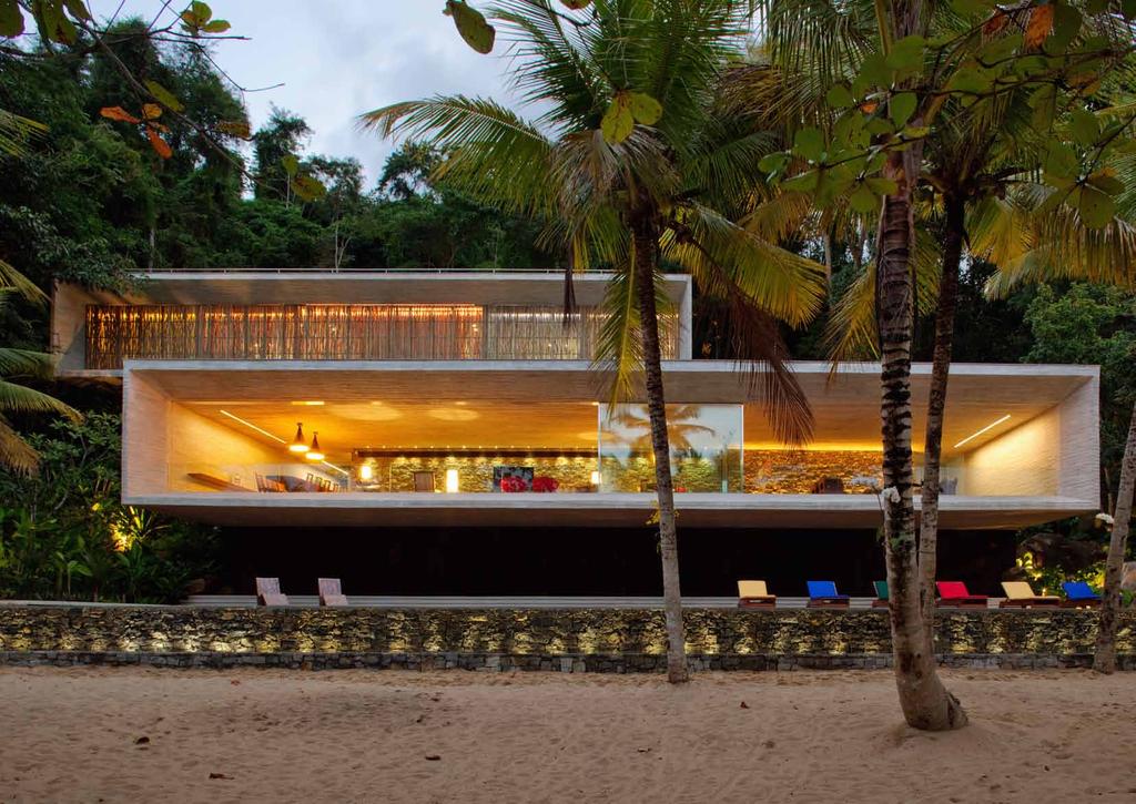 a beach house floating out of the tropical mountain side like two drawers in