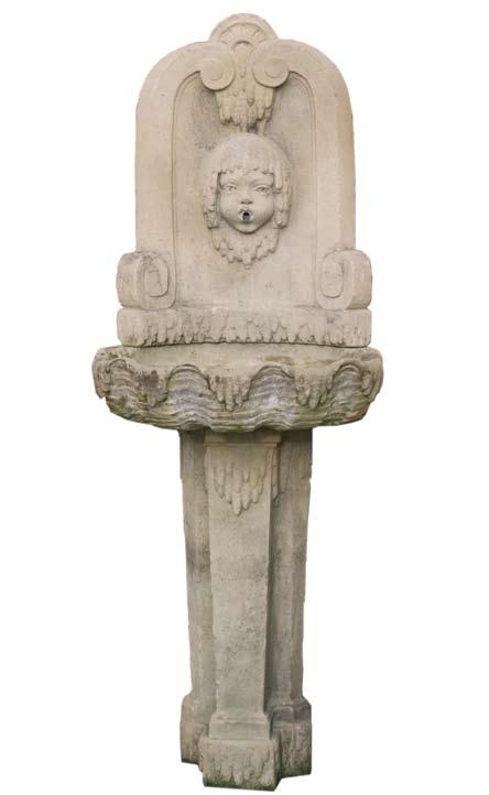 An early 20th century French carved stone corner wall fountain, circa 1910.