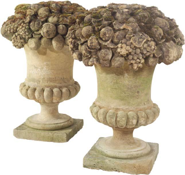 A pair of early 20th century, Bath stone fruit basket finials, circa 1900, having lobed base rising up to a profusely carved and
