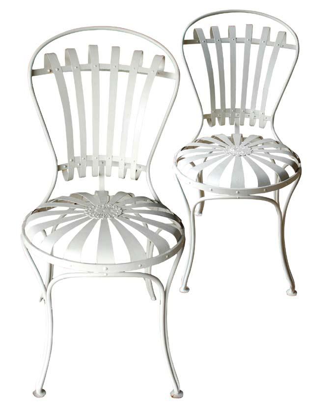 A pair of early 20th century steel-sprung garden chairs after designs by