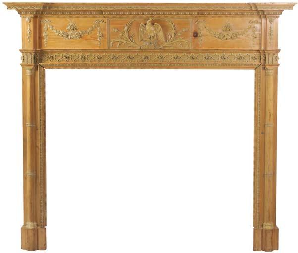 A George III pine and composite fire surround A George III, circa 1800, pine and composite fire surround; the central tablet having phoenix, reed and thistle decoration flanked by swags of grape and