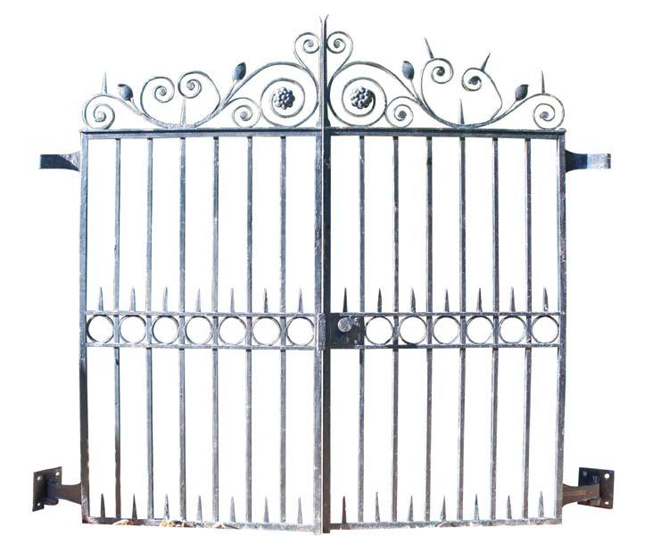 A pair of mid century, circa 1950, wrought iron gates having scroll and flower decoration.