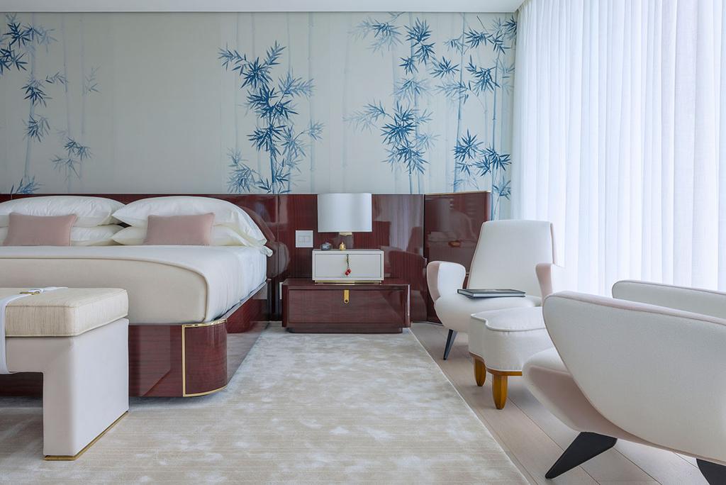 A subtle abstract floral pattern used above the bed creates a mural-like accent in this bedroom designed by Rome-based architect and designer Achille Salvagni.