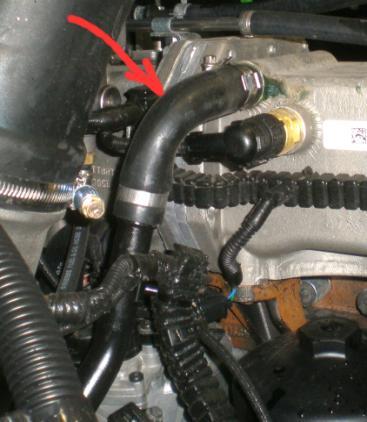 13. Blowing air through the thermostat holes. HOSE TO LPCAC THERMOSTAT HOUSING a. Disconnect top radiator hose from primary radiator. Blow air into radiator.