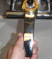 To fix the spout in the straight position: 1. Rotate the spout so it is positioned straight out over the basin.