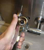 Remove handle by unscrewing the locking pin and carefully lifting without rotating the mixer s spindle