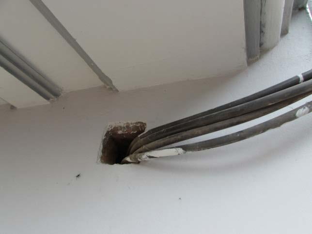 Finding No: E- 7 Category: CABLE & CABLE SUPPORT Cable passing through the wall not sealed and protected. Cables passing through permanent walls must be protected in steel pipes.