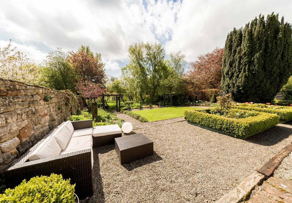 EXTERNALLY The formal gardens sit to the front of the property and have been landscaped to create a variety of interesting areas.
