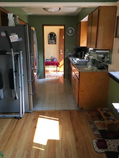 1. Kitchen Room Kitchen Walls and ceilings appear in good condition overall. Flooring is linoleum and wood. Heat register present.