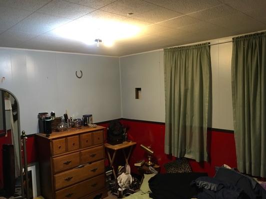 1. Bedroom Room Basement Bedroom 1 Walls and ceilings appear in good condition overall. Flooring is concrete.
