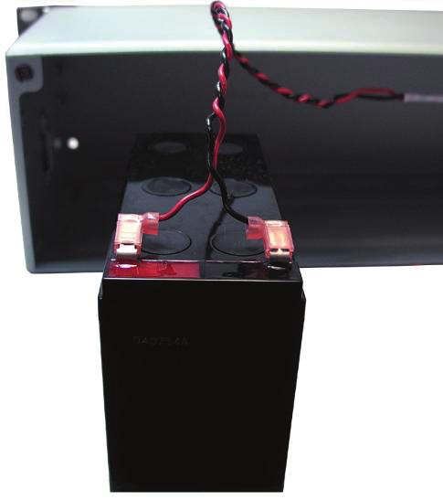Connect the cable (CA112002477) to a battery. Connect the red wire to the positive (colored red on the battery) and the black wire to the negative (colored black on the battery), as seen in Figure 24.