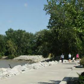 a boardwalk adjacent to a city park and community center.