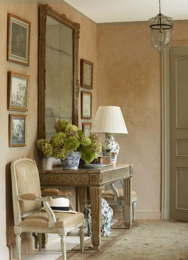 LEFT: In the entry hall, a pair of 19th-century painted chairs are covered in an antique Fortuny fabric.