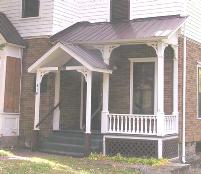 West side wraparound porch; spindle balustrades, a