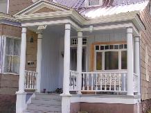 439 6th Street Wide wood steps with a spindle balustrade leading to a half-hipped partial porch with square columns and