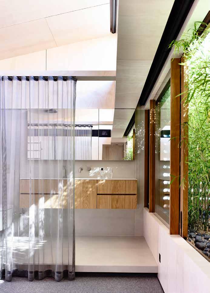 Above:The top floor houses two bedrooms and two ensuites Separating them is a lush raised garden, accessed by large sliding doors Crossventilation is achieved with this central lineal courtyard and