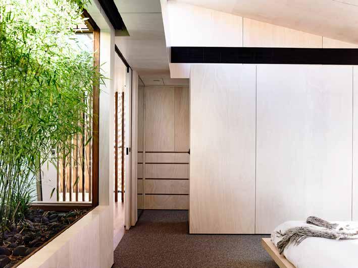 integral piece of joinery Above: Each ensuite has a mesh curtain but is otherwise open to the bedroom and raised garden to maximise the sense of space Sloping ceilings allow space for high-level