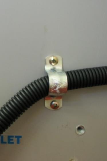 The saddle clamp must be positioned over the pilot holes provided, otherwise the conduit will