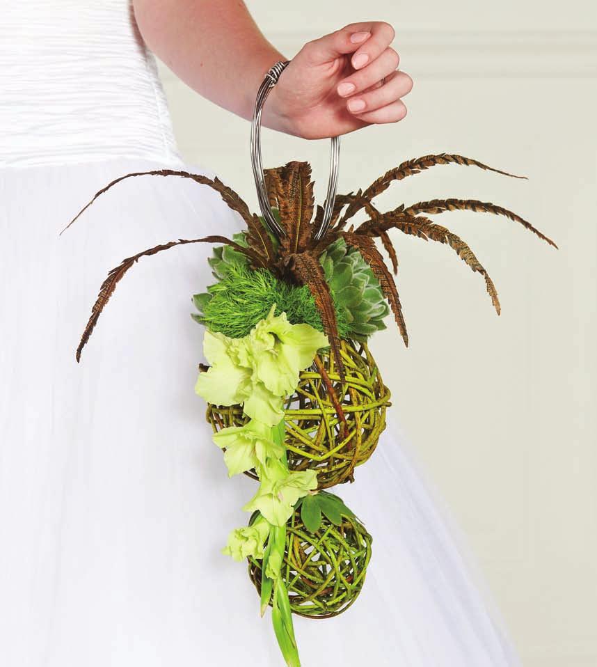 (Above) Green Gladiolus, Echeverias, faux pheasant feathers and curly-willow spheres are designed on a frame