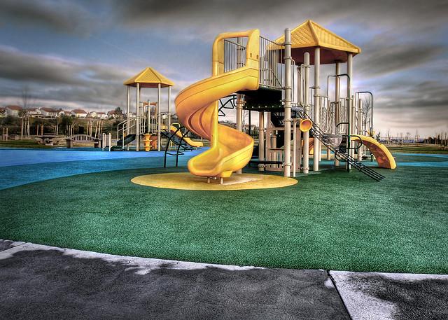 An enclosed area with age appropriate play equipment and special facilities shall be provided, including: Provide play equipment such as climbers, slides, play walls and playhouses, play sculptures,