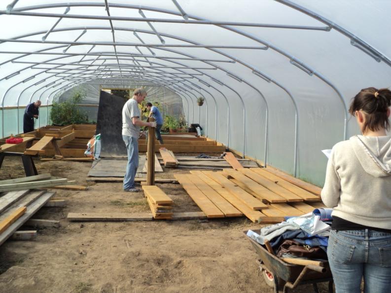 The Trading Shed with millionaire Marcelle Speller Community Polytunnel volunteers building raised beds The