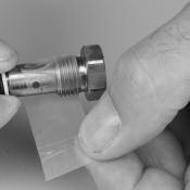 Protect the threads with thread protector, tape or paper. 2. Insert the filter and holder into a 3/16 nut driver. c.