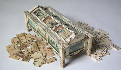 PLAYING CARD BONE BOX, circa 1800, contains 45 bone playing cards and 28 bone dominoes in rectangular bone box on wooden structure,