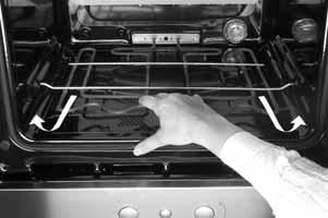 Lower the two catches. 3. Close the oven door fully. Attention:  the oven door and hinges.