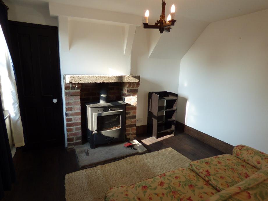 main feature of the room being a brick built fireplace with stone mantel and
