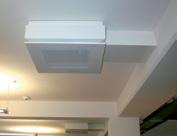 Cabinet includes outlet air discharges designed to direct the airflow upward for reducing drafts.