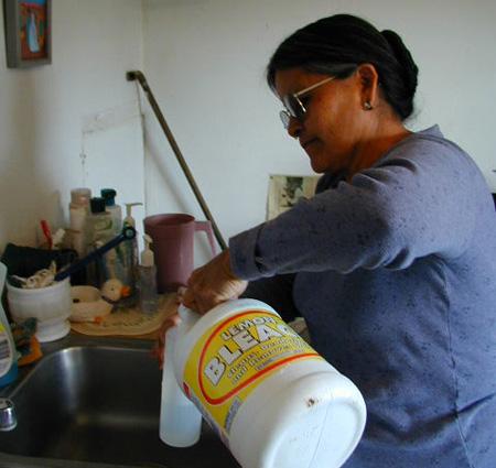 Woman preparing bleach solution