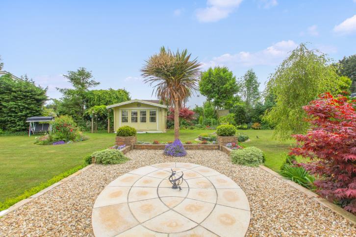 The gardens feature a timber summer house for tranquil relaxation or wonderful hobbies area.