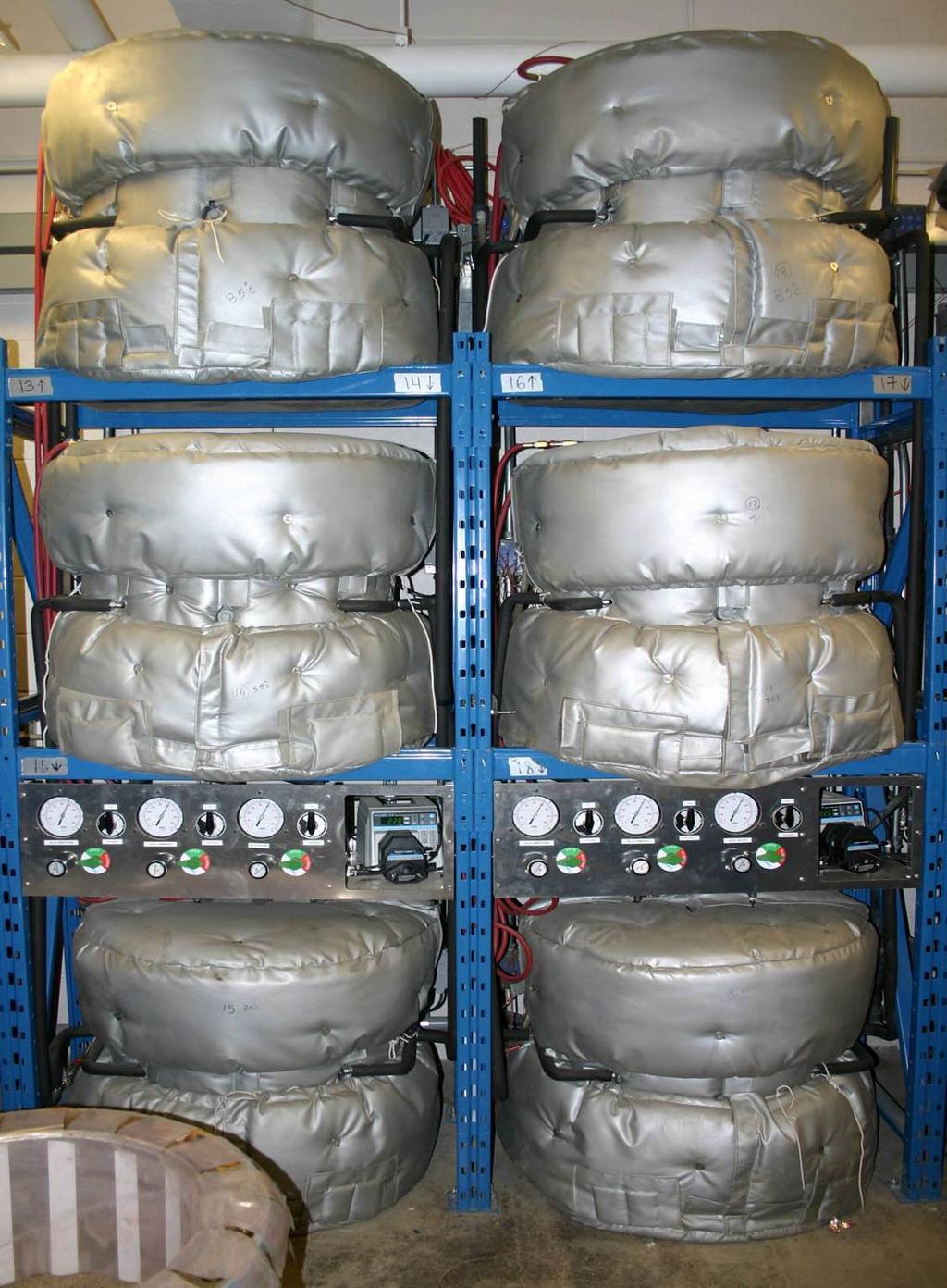 Figure 8. Photograph of six GLLSs tests in progress and an additional one (lower left) being assembled. Table 6.