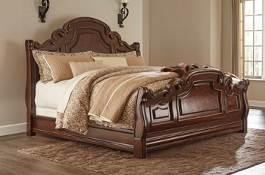 burl veneers with walnut inlays, and furniture grade resin parts in a deep brown finish with metallic detailing Serpentine shaped cases with large scale ornamental details throughout Bed design