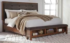 B594 Ralene (Signature Design) Contemporary group crafted in a timeless casual lifestyle design Made with Acacia veneers and hardwood solids in a brown finish Bed features thick padded headboard with